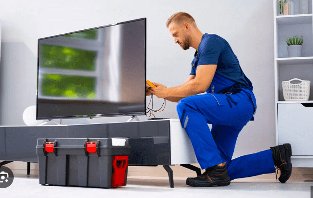 TV Check-up Service TV check-up service technician inspecting television for display and sound issues